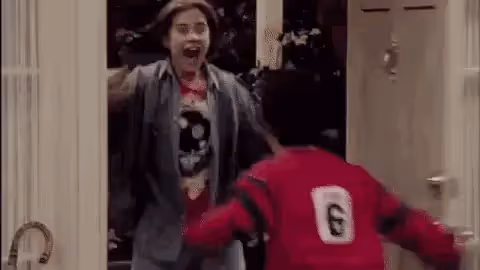 Door open and two friends excited to see each other