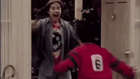 Door open and two friends excited to see each other
