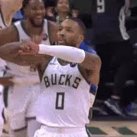 Giannis Antetokounmpo is dribbling a basketball
