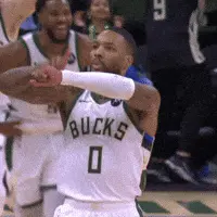 Giannis Antetokounmpo is dribbling a basketball