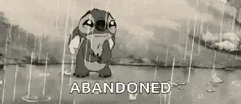 Sad Stitch standing in the rain with the word Abandoned.