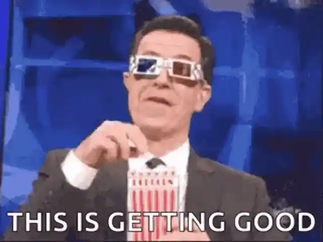 Stephen Colbert wearing 3D glasses and holding a bucket of popcorn with the caption 'THIS IS GETTING GOOD'.