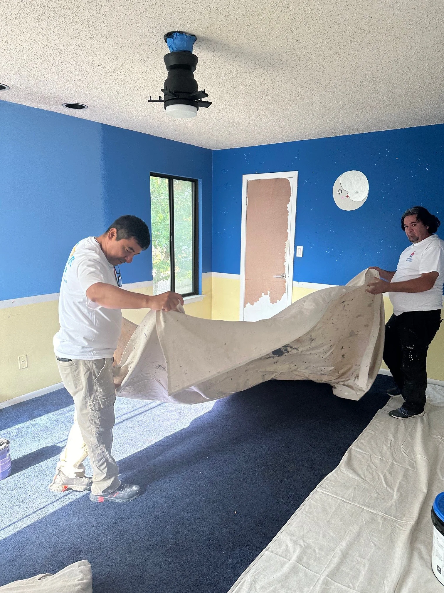 Painters prepping for painting a home