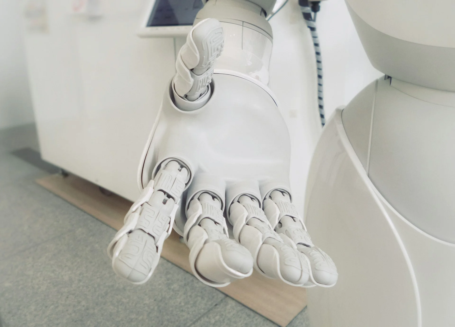 A photograph of a robot holding out its hand to you. This is showing that technology can be there to support. 