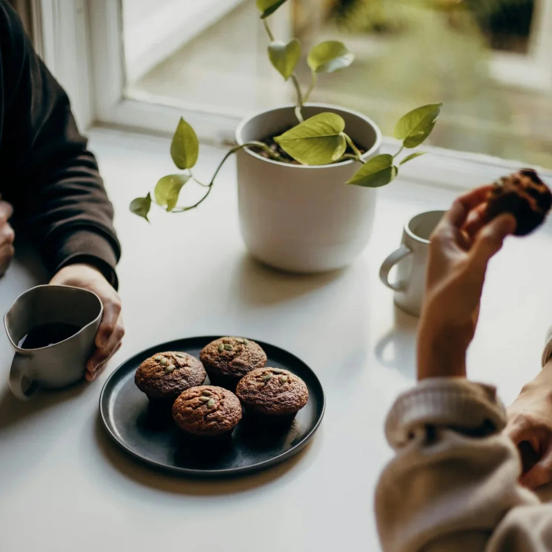 A photograph of two colleagues sitting opposite each other having a discussion.