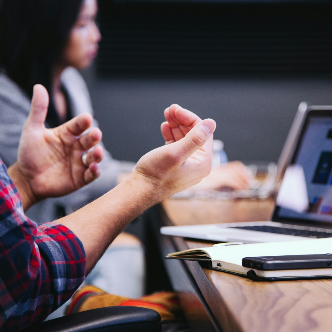 A photo of a person's hand gestures whilst speaking.