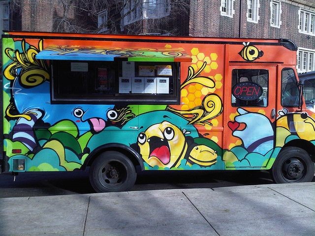 A bus with graffiti on itDescription automatically generated with low confidence