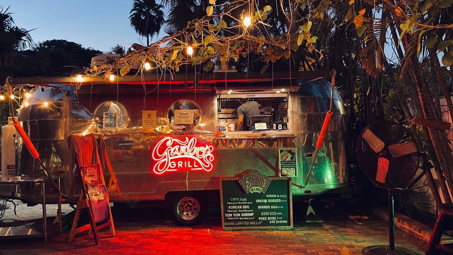 A picture containing text, outdoor, treeDescription automatically generated