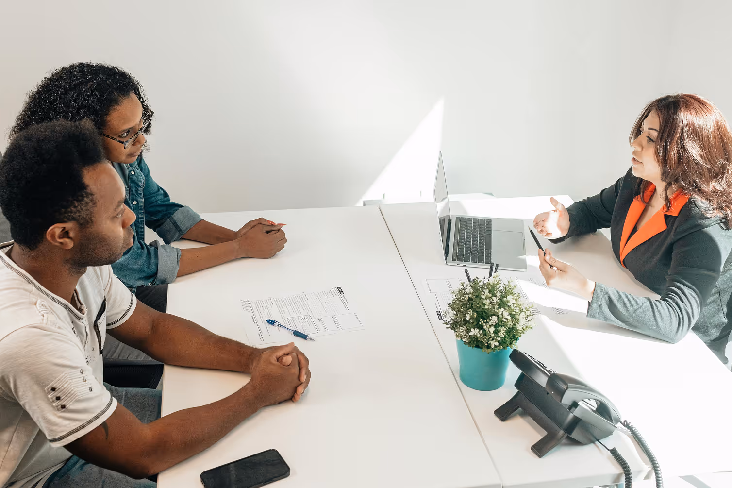 People around a meeting table in office setting.