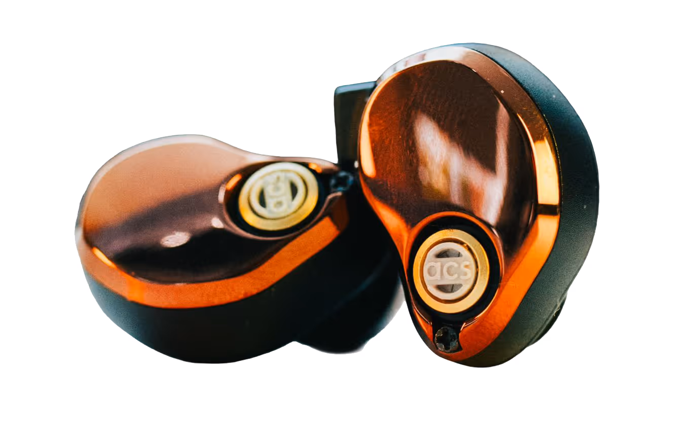 Two sleek, metallic earphones with intricate detailing, placed on a white surface.