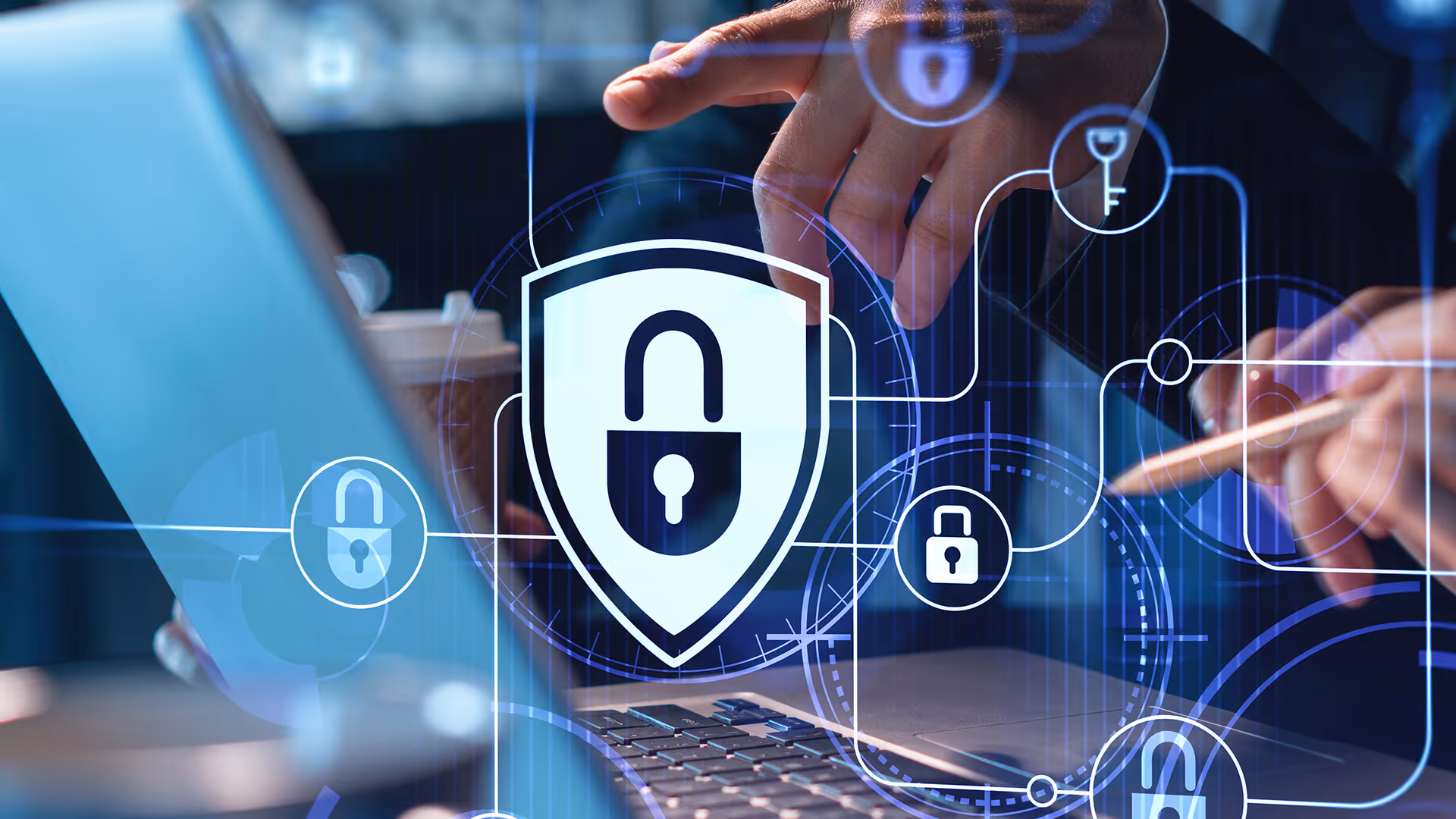 Shield with padlock icon hovering over laptop, representing card issuing settlement cover