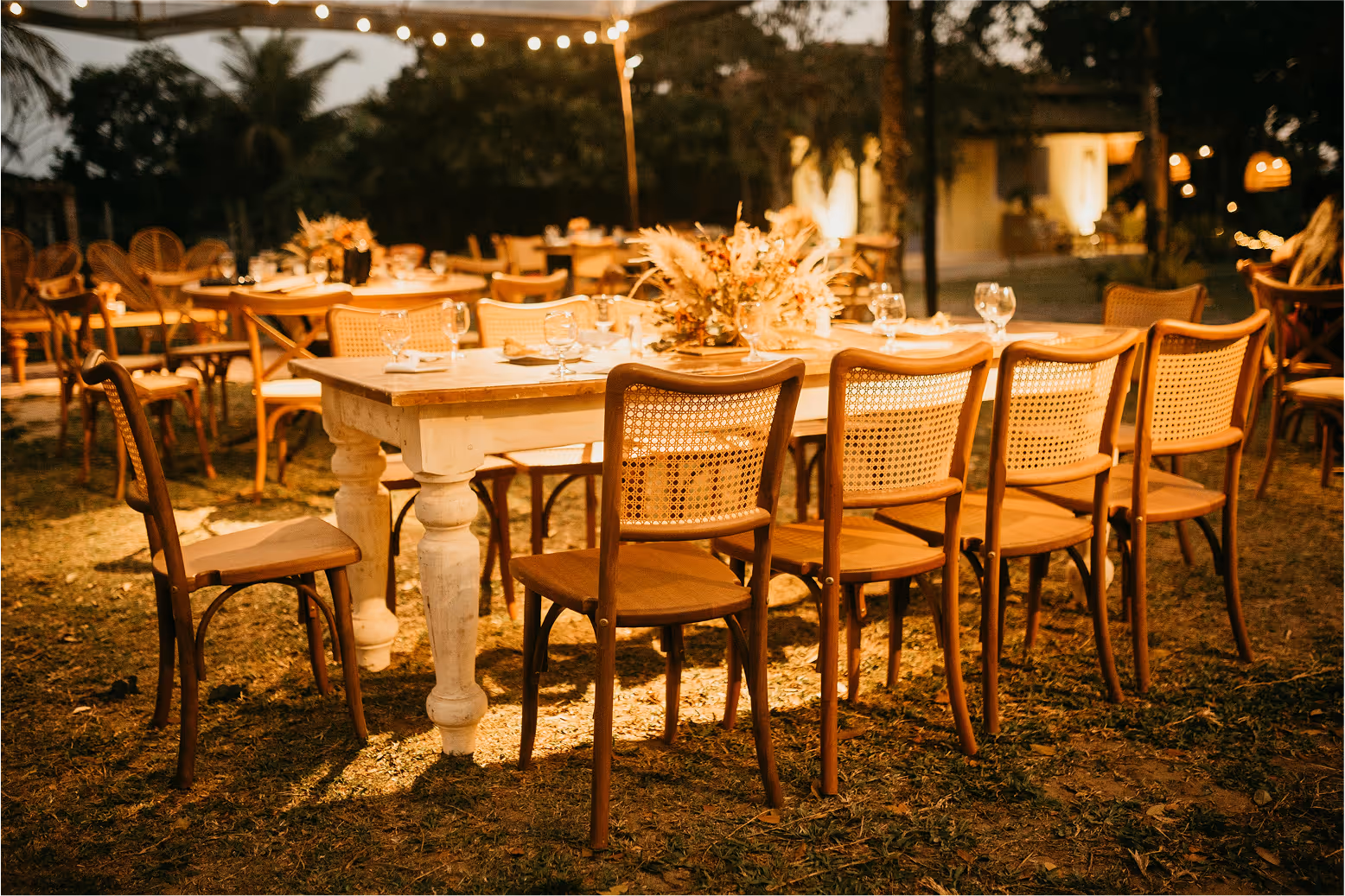 A moody and intimate image of seats and a table with lights around it.