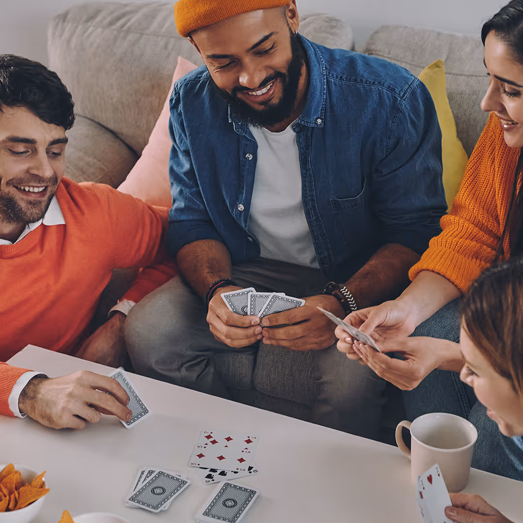 group of young adults playing card game. Preem coaching and mentoring services in dallas tx