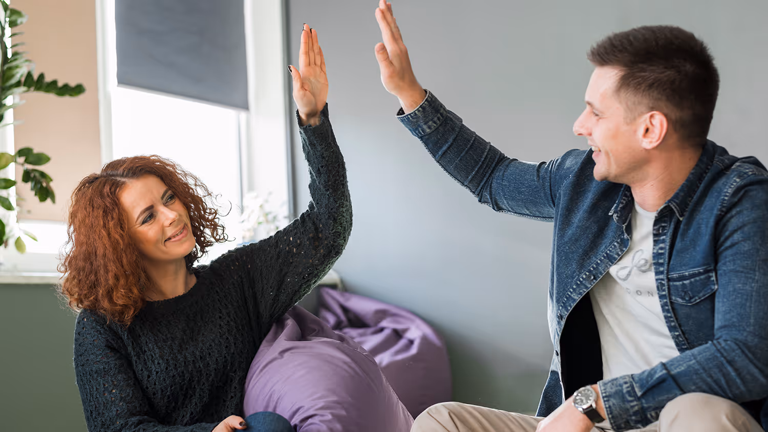 Two people high five. Preem coaching and mentoring in Dallas TX