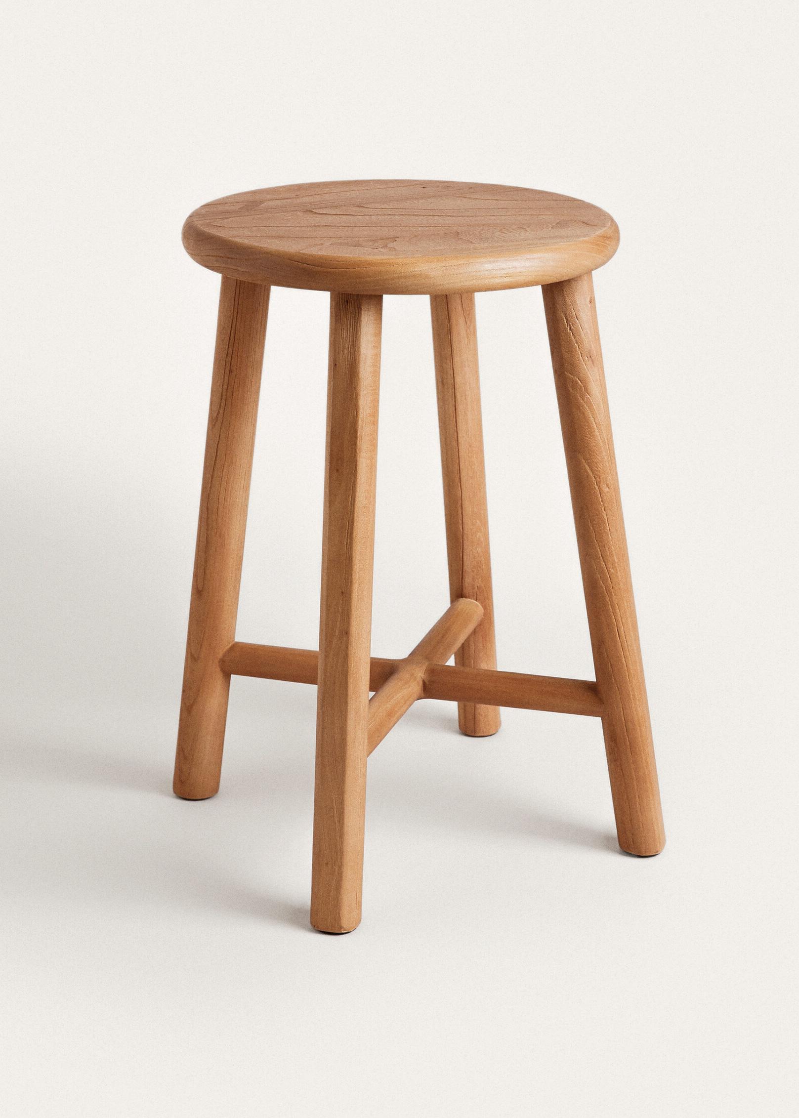 Tall Teide stool in warm honey-toned wood, with a round top, four splayed round legs and a cross of stretchers, on a plain light background.