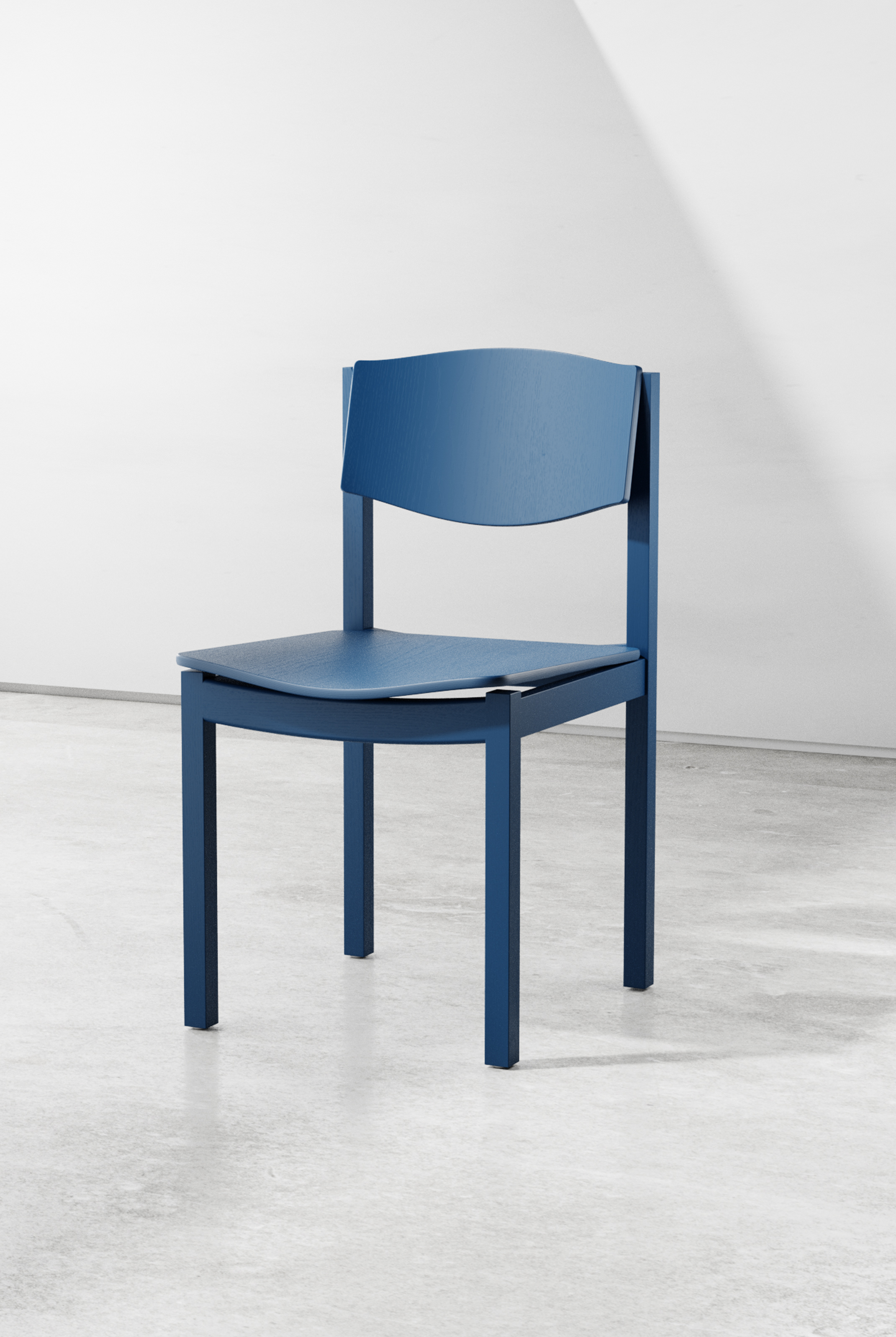 Front three-quarter view of the blue chair, showing the curved backrest and seat floating within the square frame.