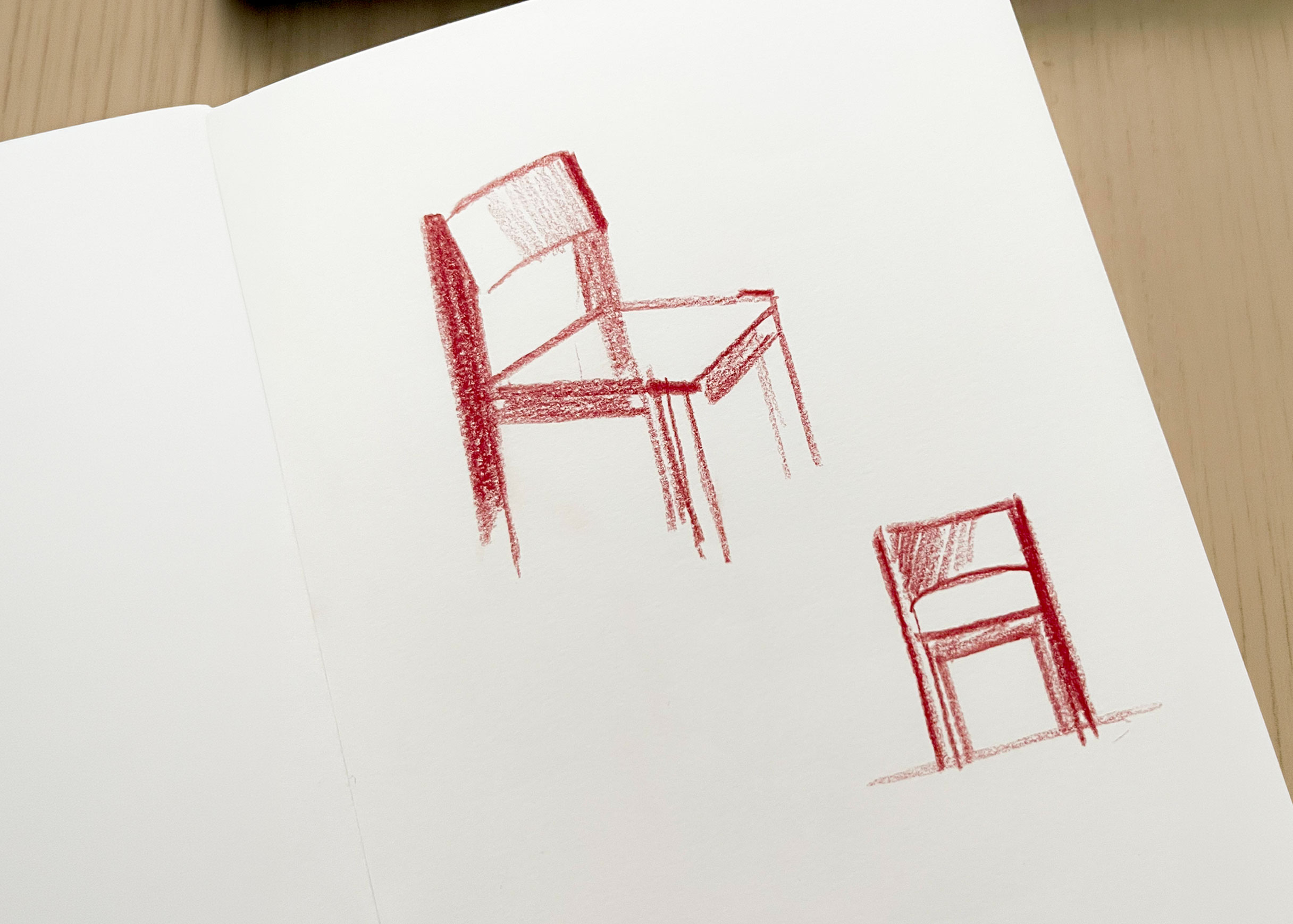 Red pencil sketches of the Ray chair on white paper, one large three-quarter view and one smaller front view.