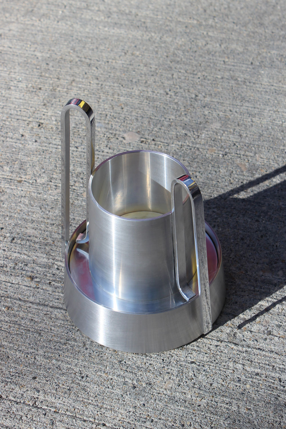 Closer, higher view of Bloom on concrete, showing the hollow inside of the vessel and the recessed ring of its base.