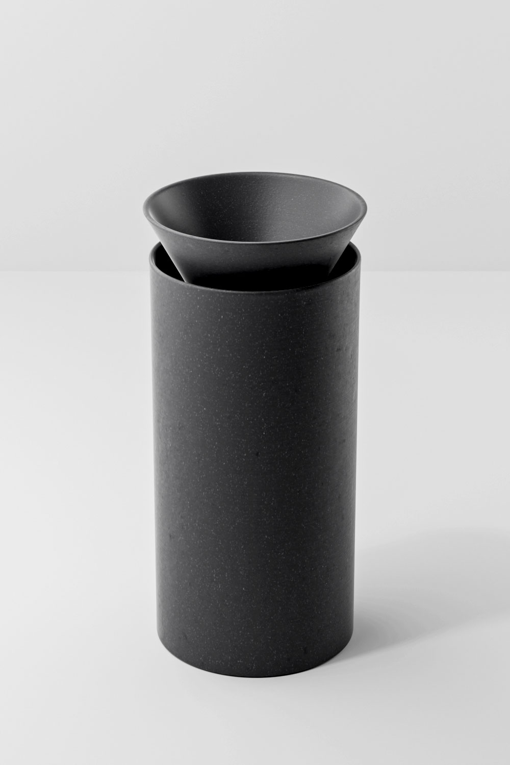 Closer, slightly higher view of the dark terracotta Olla, showing its speckled surface and the filter holder seated in the opening.