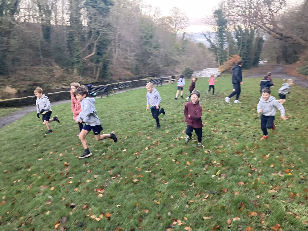 kids running and playing next to river