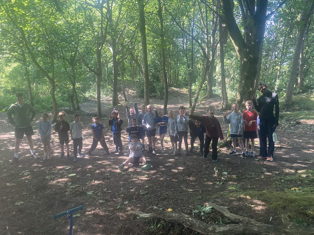 kids standing in a line in the forest
