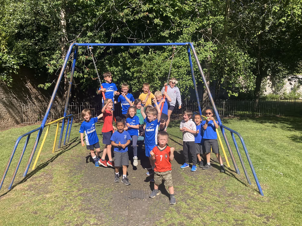 group of kids on the swings in the playpark