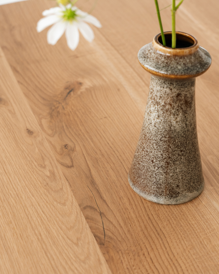Fine cracks running along the grain of a wooden tabletop