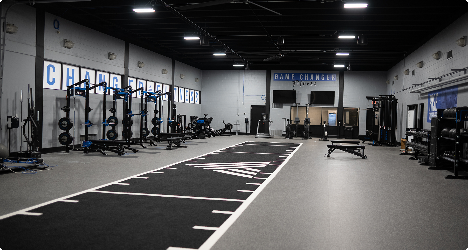 A gym with a black and white line on the floor.