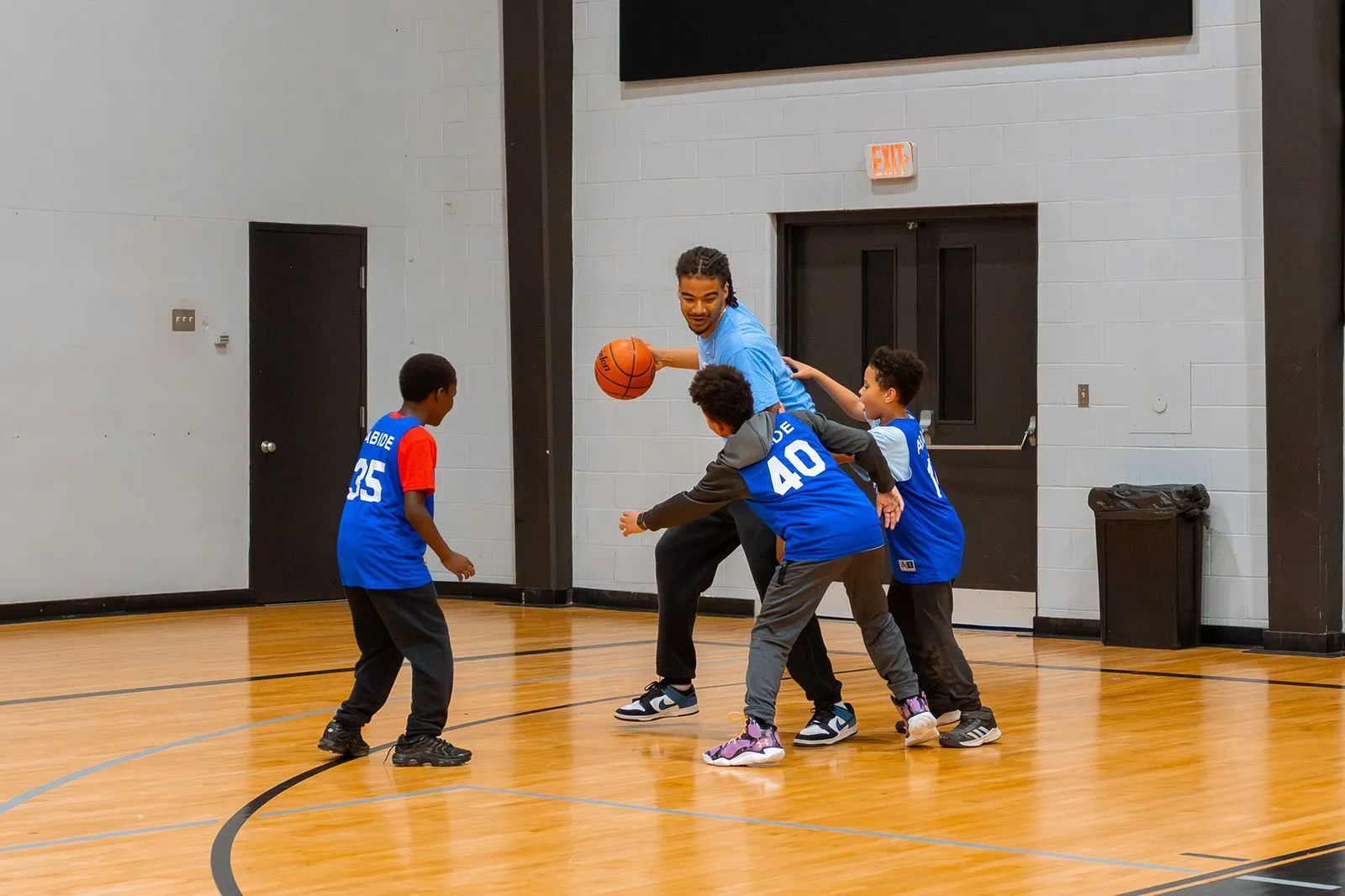 A group of young boys playing a game of basketball.