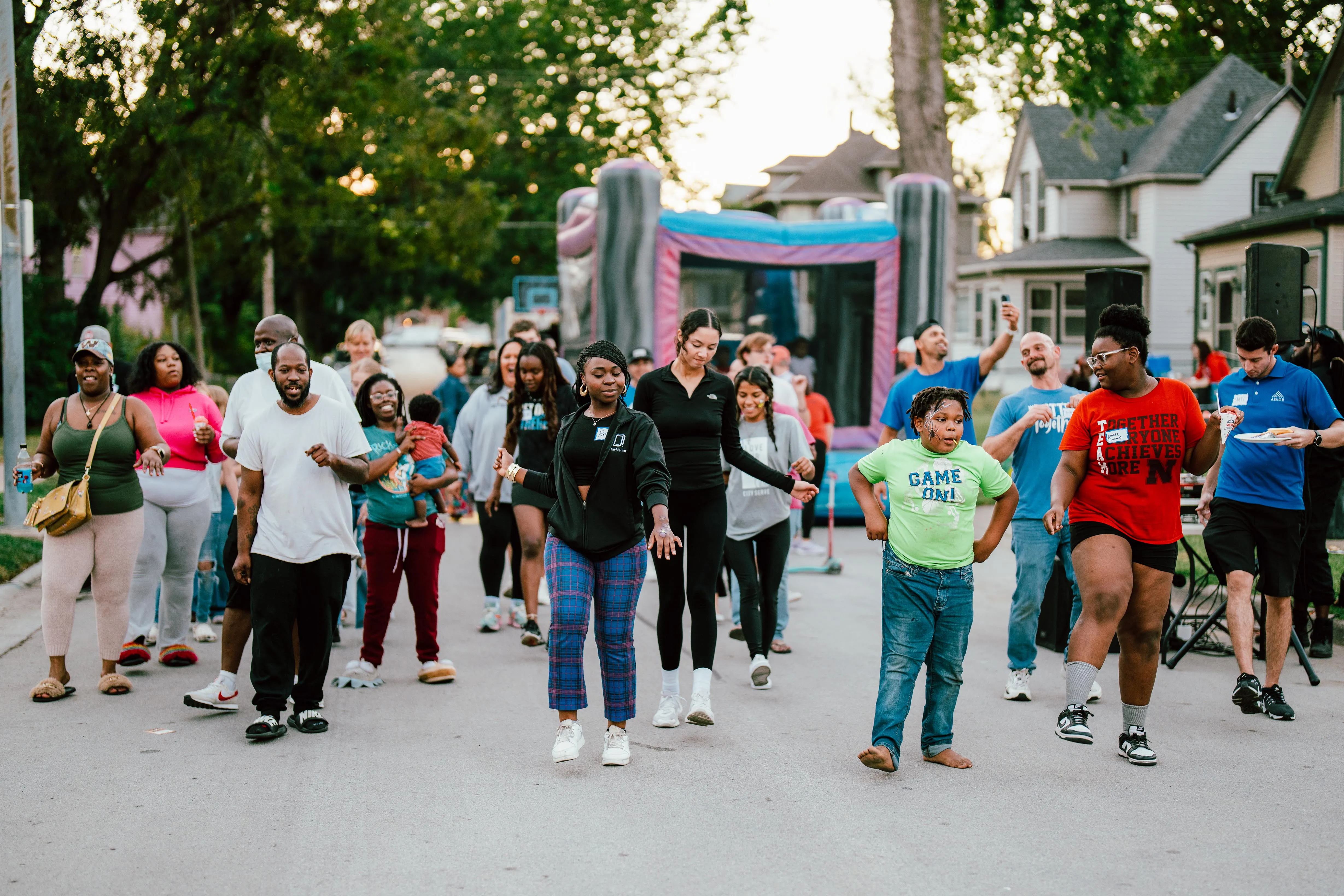 A group of people walking down a street.
