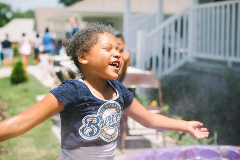 A little girl that is standing in front of a frisbee.