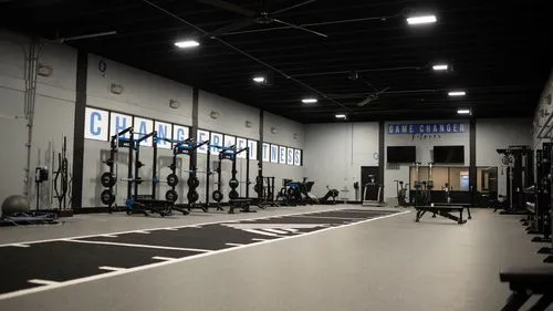 A gym with a row of exercise equipment.