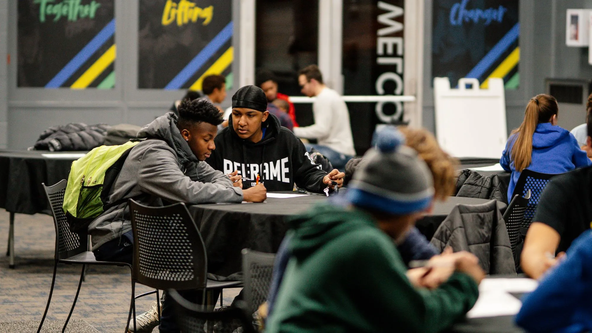 A group of people sitting around a table.