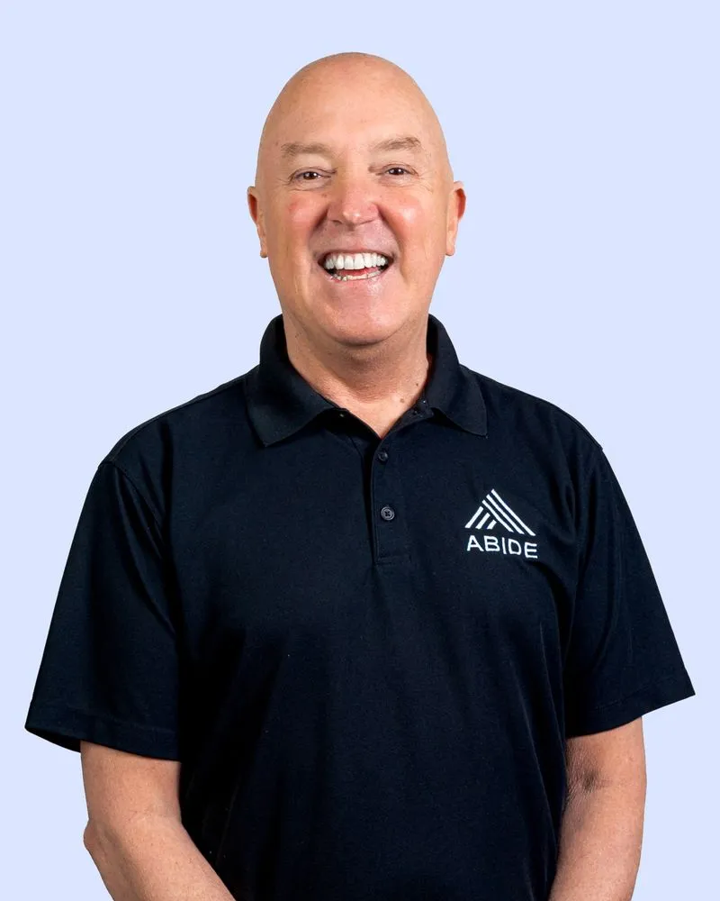 A man with a bald head wearing a black shirt.
