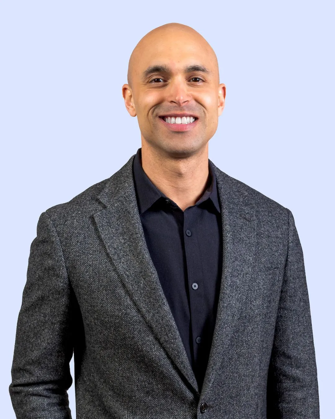 A man with a bald head wearing a suit.