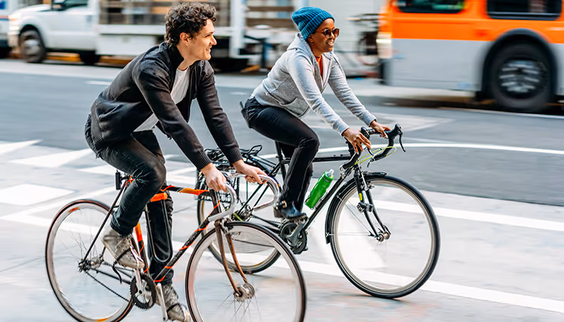 Photo of women on bikes riding through city