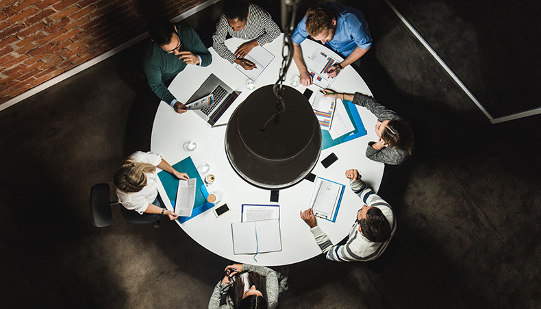 Photo of office workers viewed through glasses