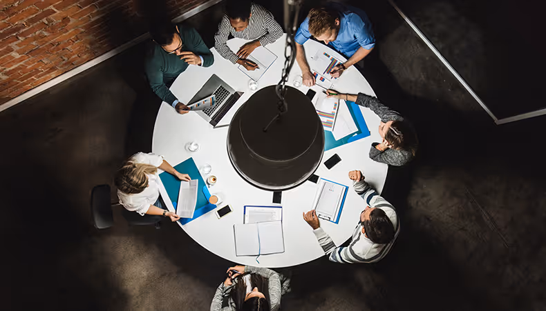 Photo of office workers viewed through glasses
