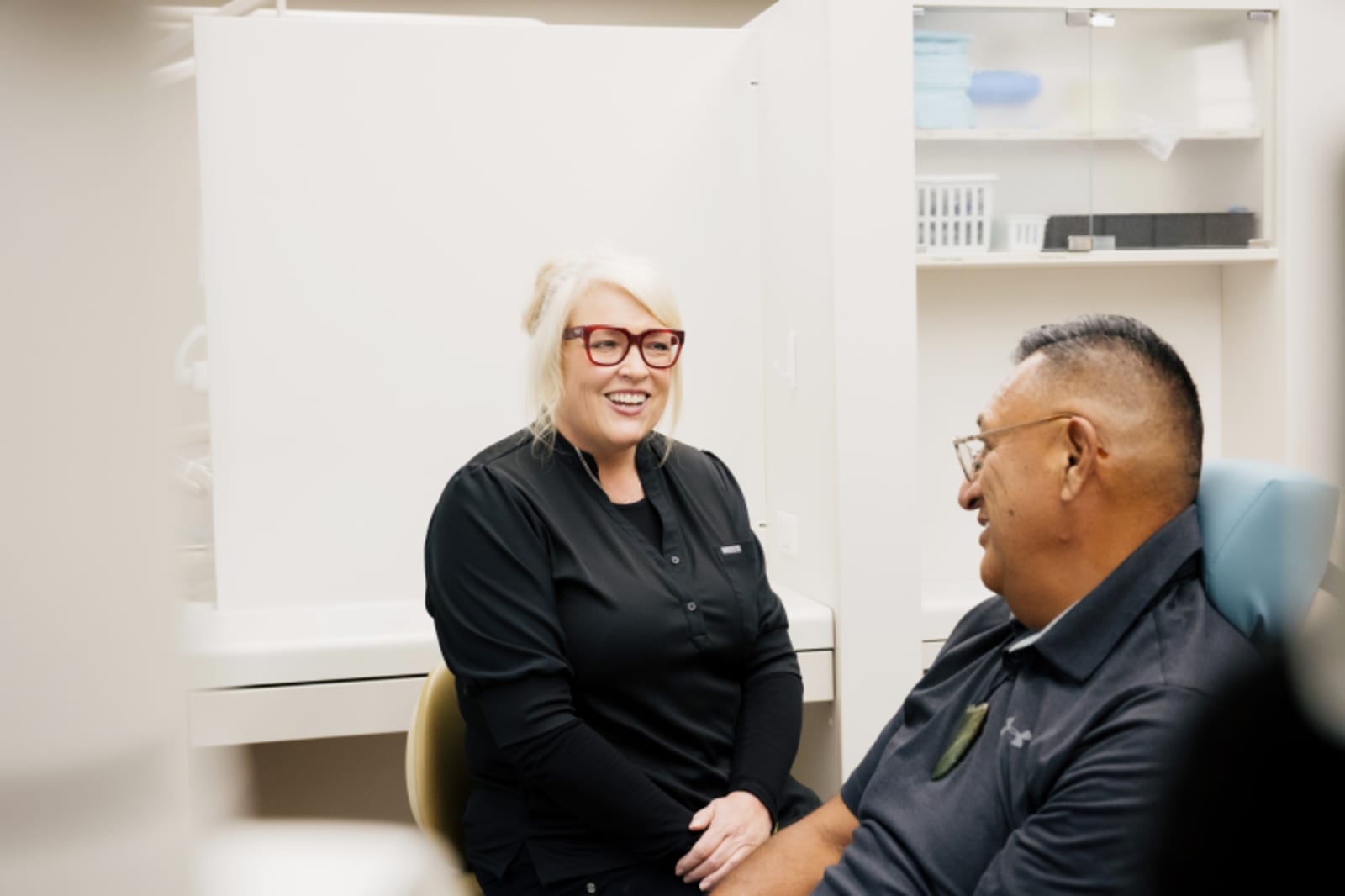 Two dental professionals discussing treatment plans in a consultation setting