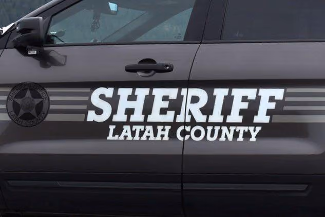 Side door of a Latah County sheriff vehicle with bold white text and a star badge emblem.