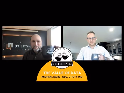 Two men holding coffee mugs in video talk titled The Value of Data with CEO Michael Nark.