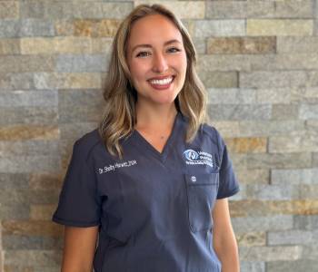 Professional picture of a woman wearing grey scrubs.
