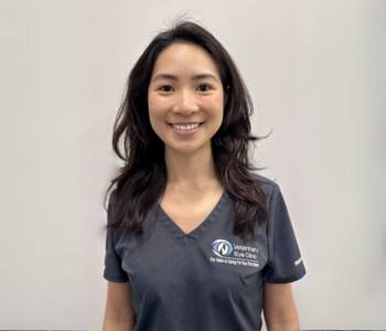 Professional picture of a woman wearing grey scrubs.