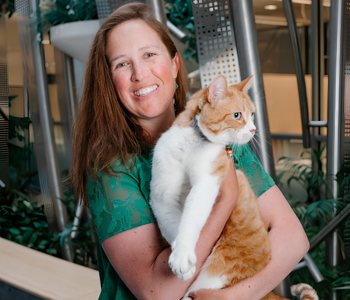 Picture of Dr. Sam Evans holding a orange and white cat.