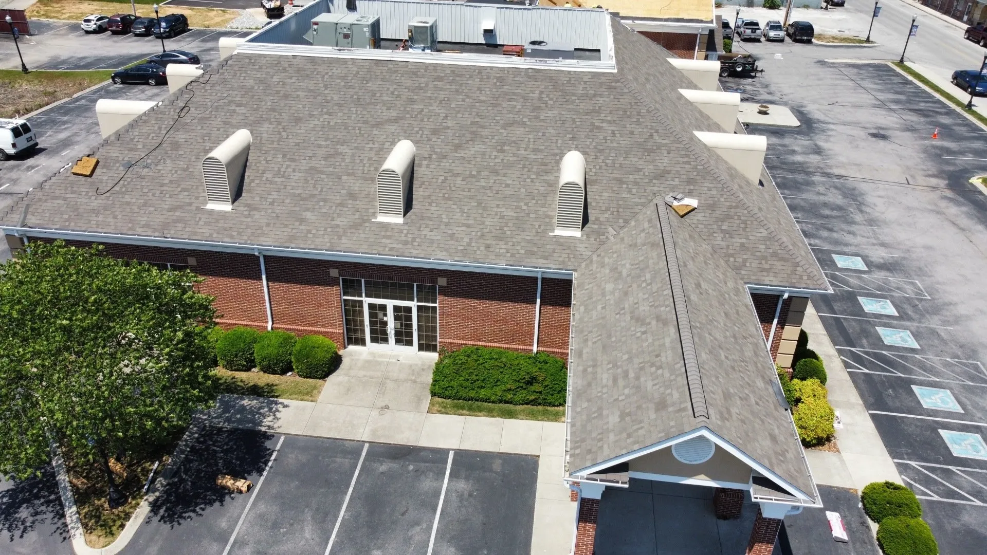 Commercial roofing services banner featuring modern industrial roofline