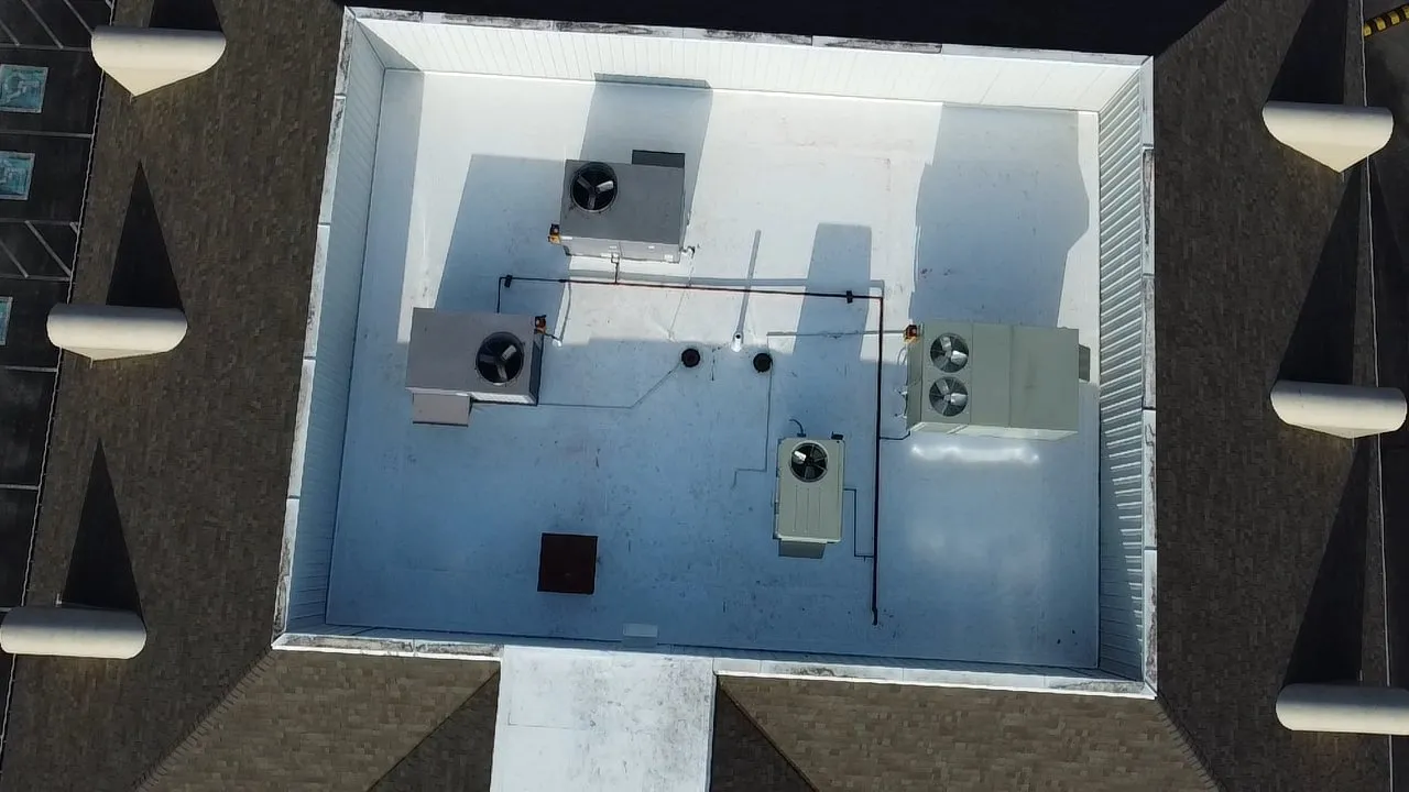 Top view of commercial roof showing newly applied membrane and vents