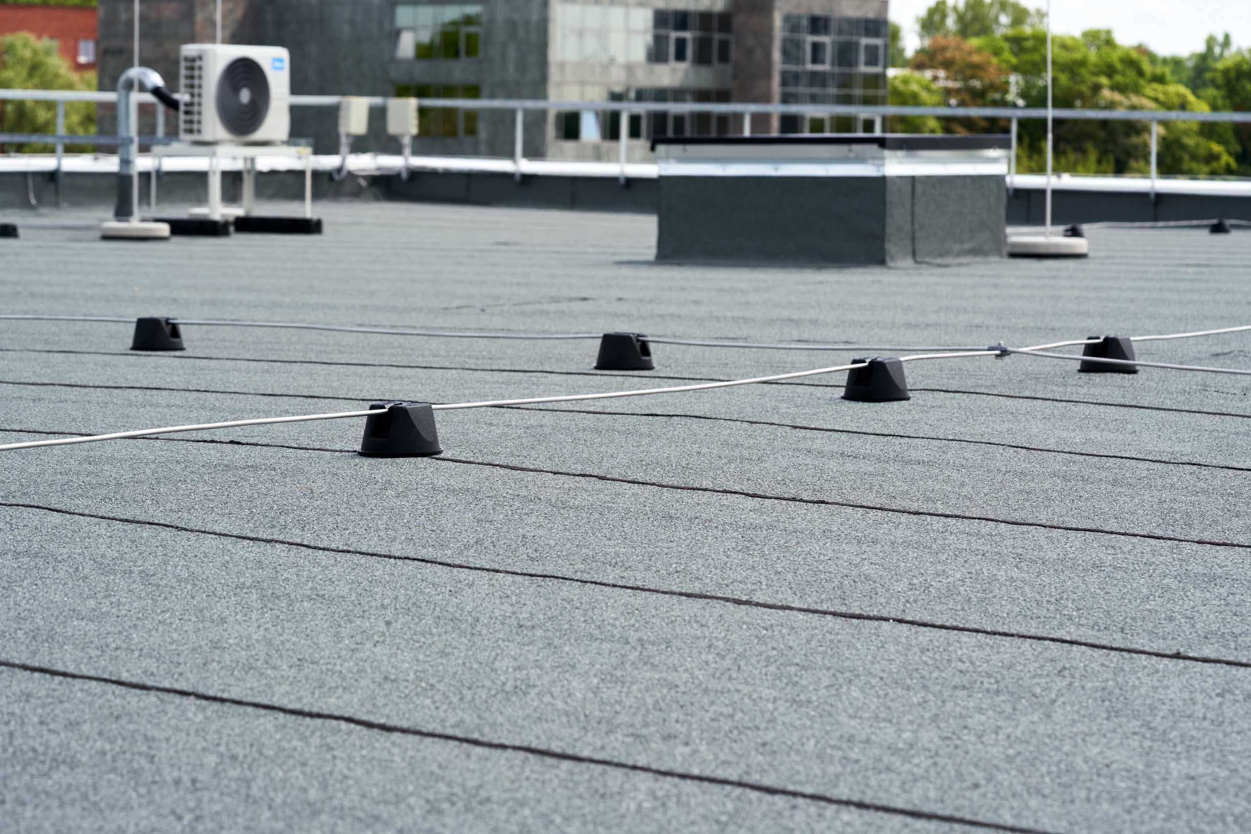 Top view of modern dark flat roof with ventilation systems