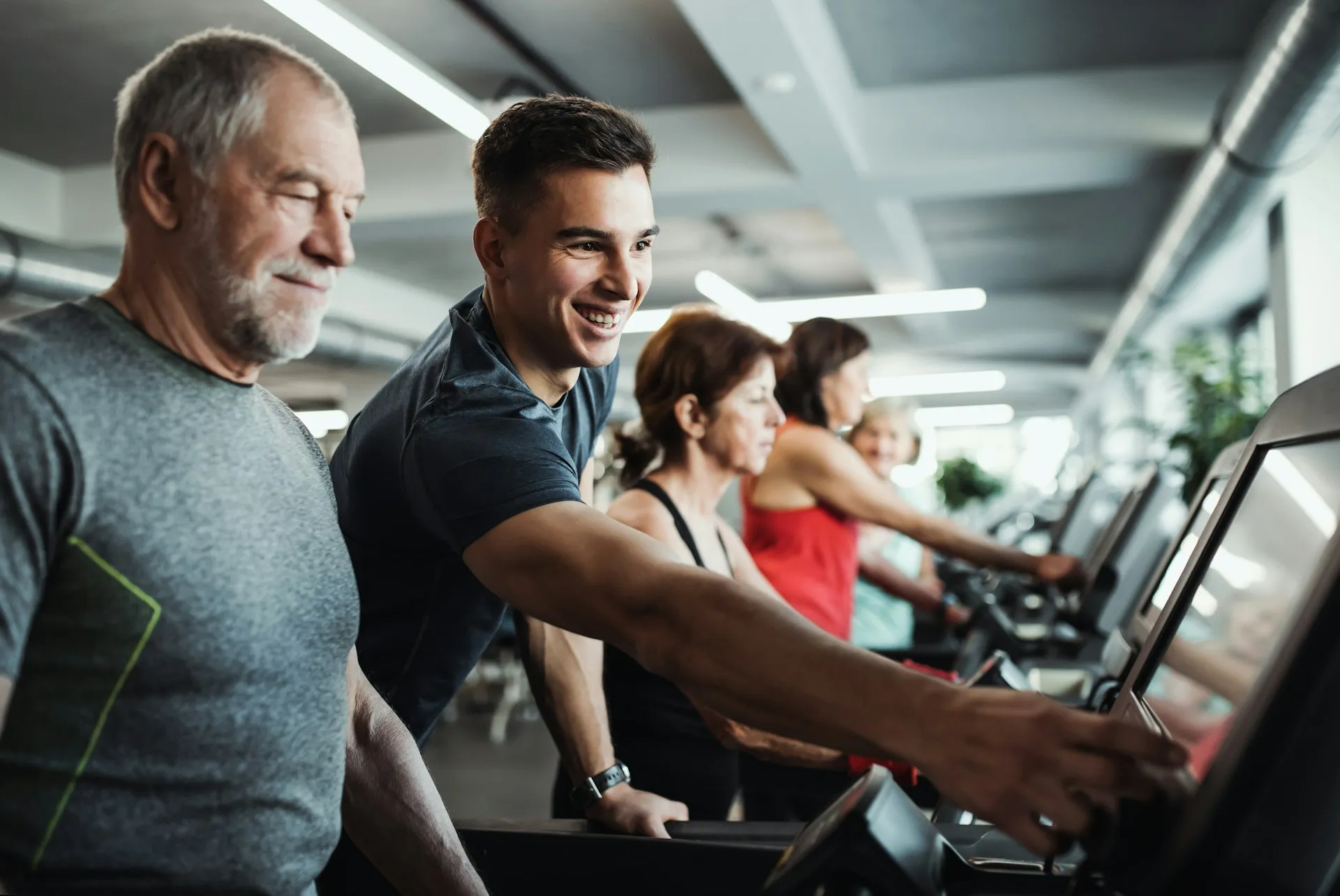 A man and woman are working out in a gym.