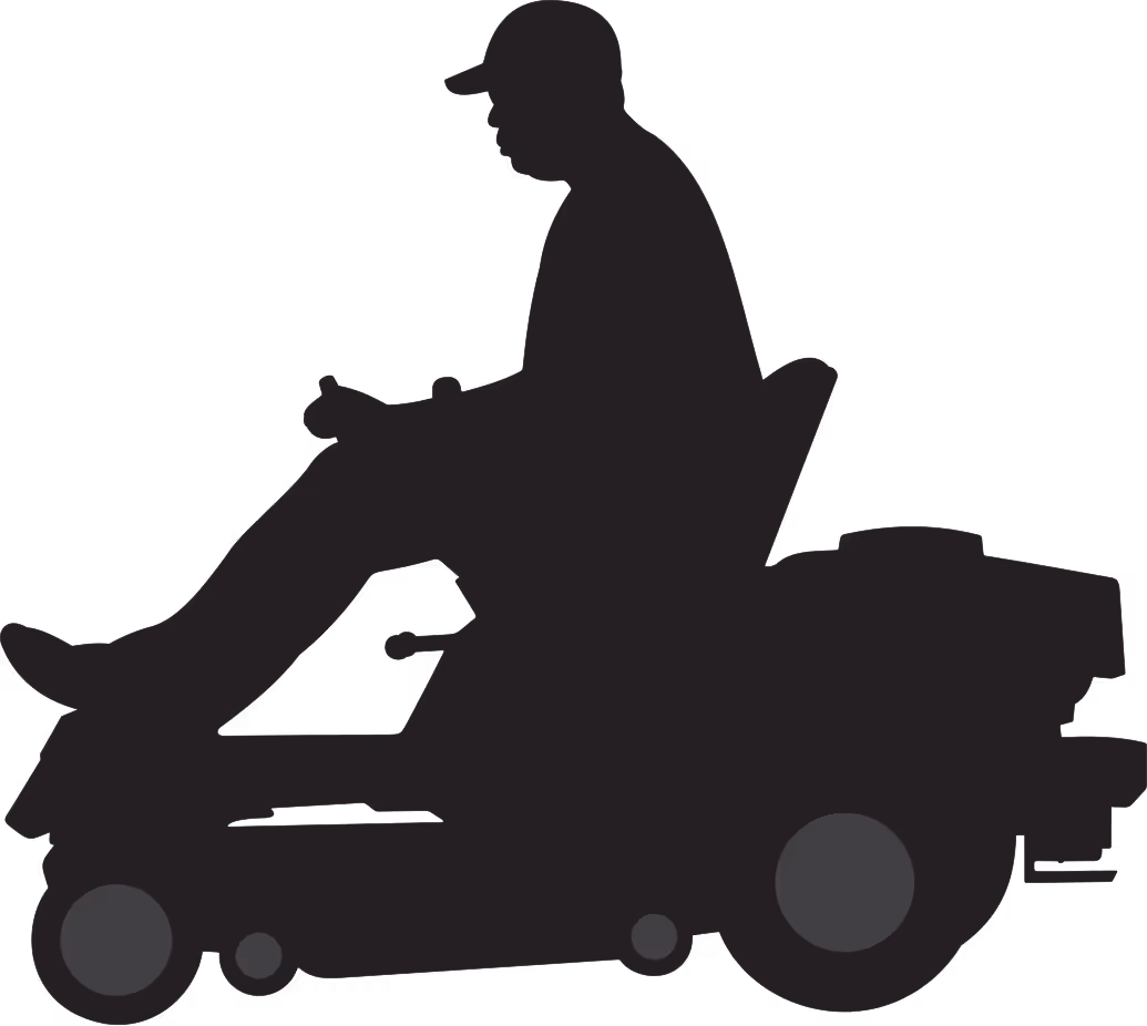 Silhouette of man on riding mower