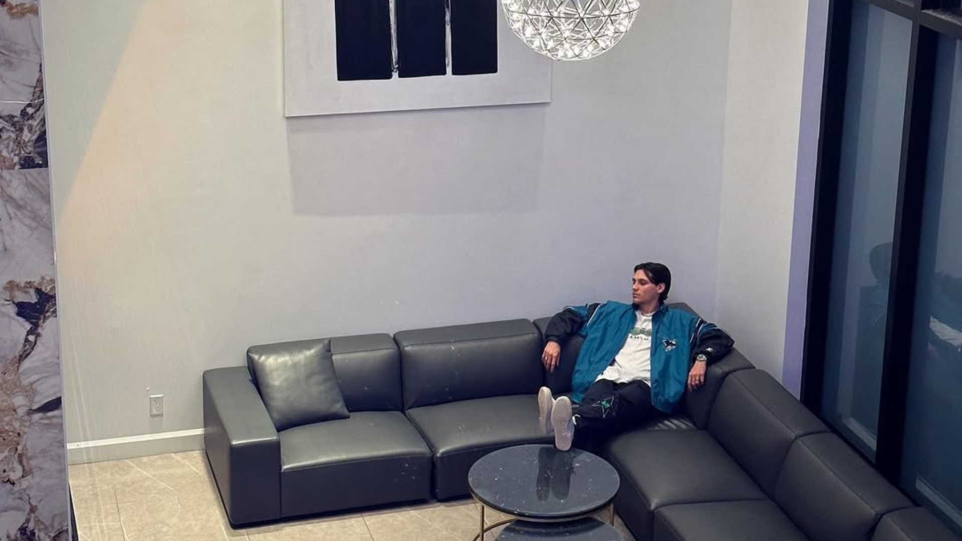 Alex The Lucky relaxing on a couch, a regular in Shahin Ouest's videos